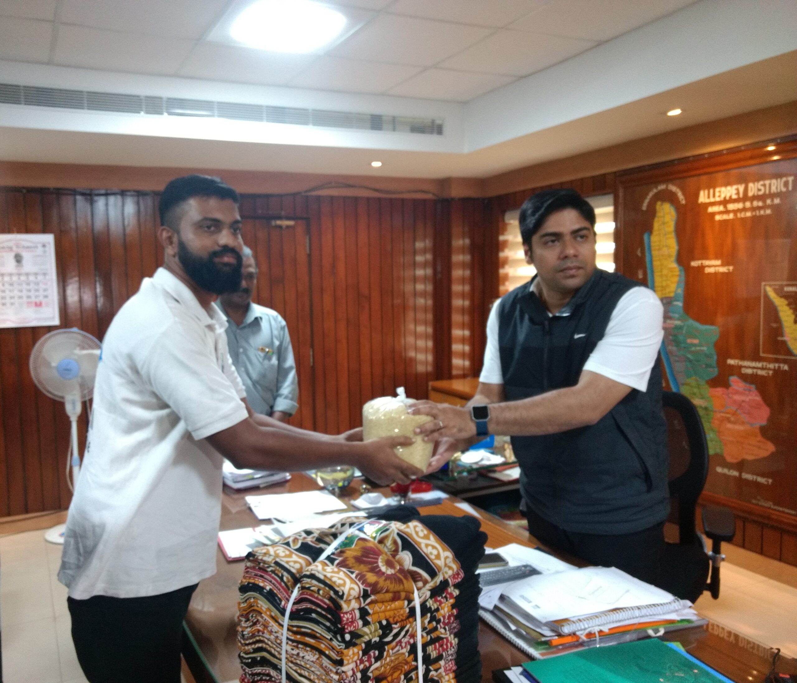 Alappuzha District Collector Suhas receiving grocery kits and clothes